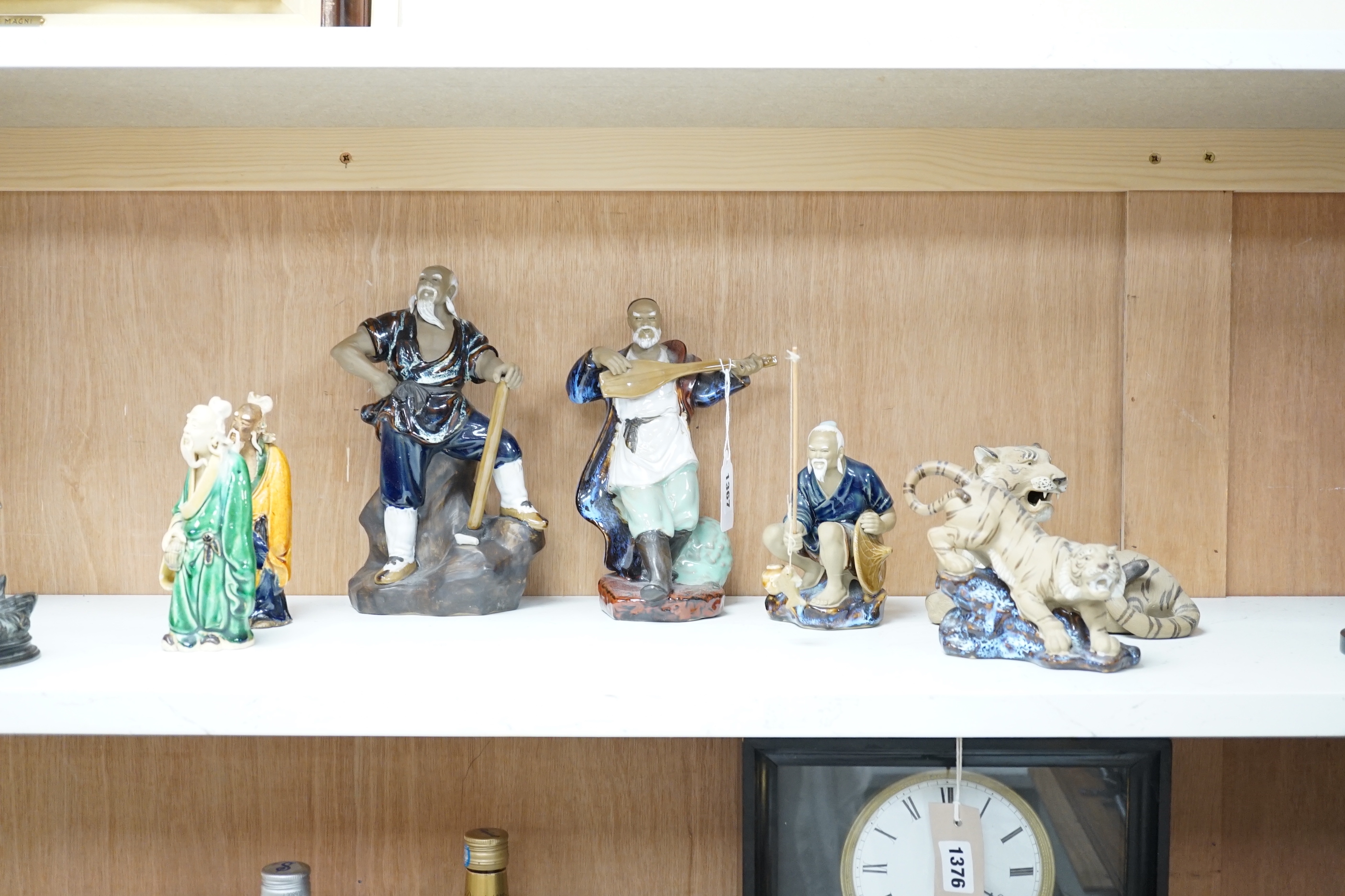 Thirteen Shiwan pottery figure groups of tigers and figures, the largest 25cm high
